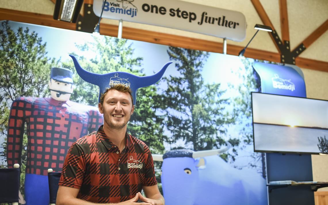 Brady Laudon, Visit Bemidji assistant director, shows off one of the Babe the Blue Ox hats that will be given away at the Visit Bemidji booth at the Minnesota State Fair. (Annalise Braught / Bemidji Pioneer) 
